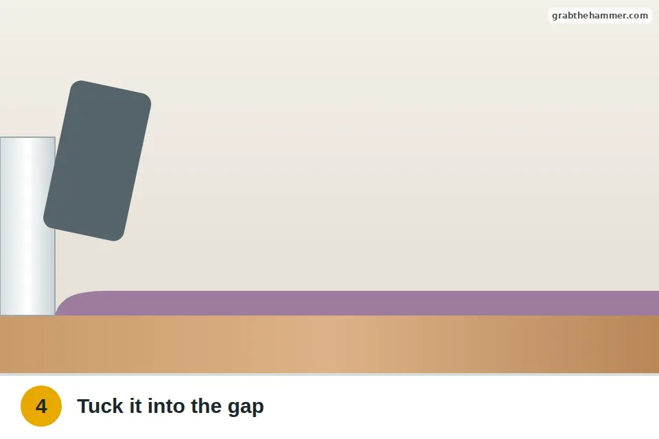 Stair tool pushing the carpet edge down into the gap between the tack strip and the baseboard