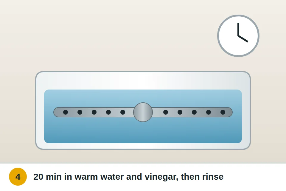 Spray arms soaking in warm water with vinegar, then rinsed under the tap