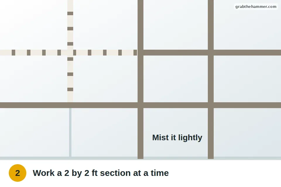 Baking soda paste spread along the grout lines of a small section of tile