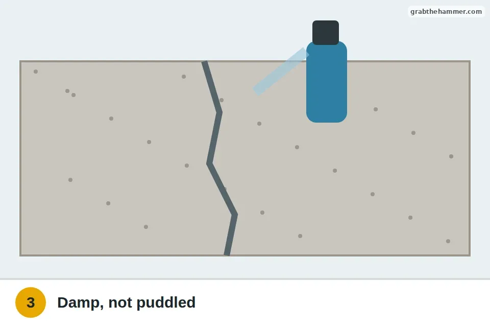 Spray bottle misting the cleaned crack so it's damp without standing water