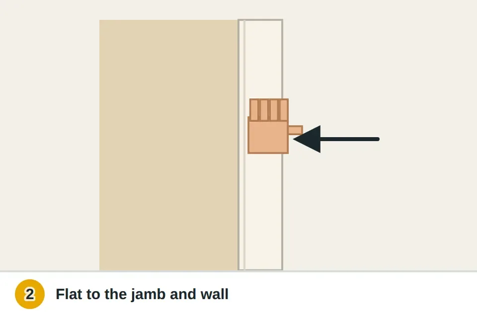 Palm pressing the loose casing flat against the wall while a nail set taps an old nail back in