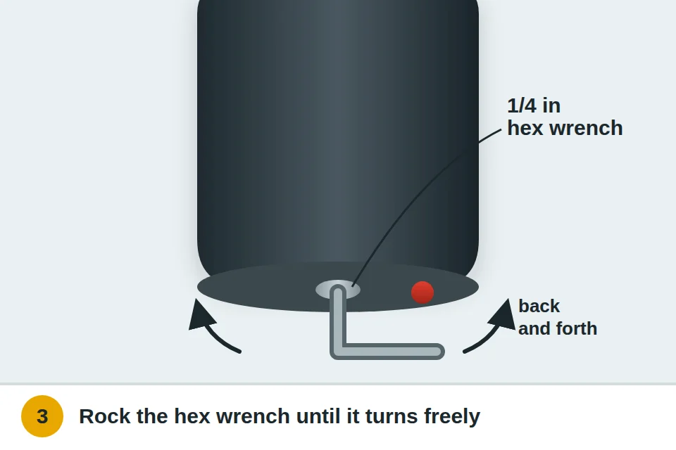 Quarter-inch hex wrench in the socket on the bottom of a garbage disposal, rocked back and forth