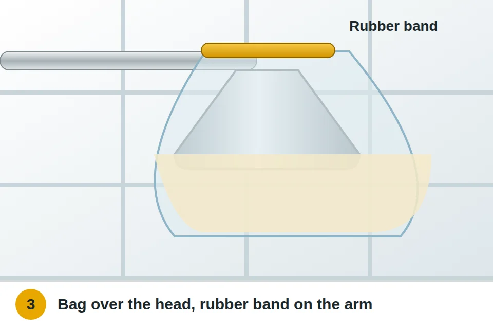 Bag of vinegar pulled up over the showerhead and held tight around the arm with a rubber band