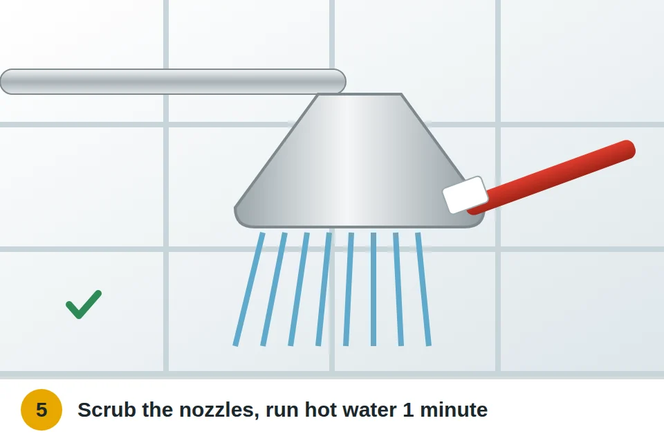 Old toothbrush scrubbing the showerhead nozzles, then hot water spraying strongly