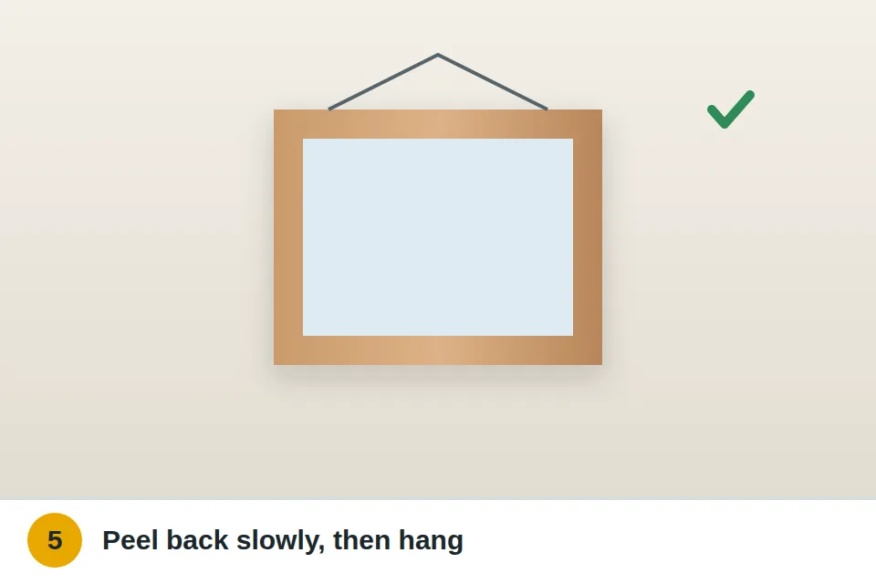Tape peeled off and a picture frame hung on the nail, level on the wall