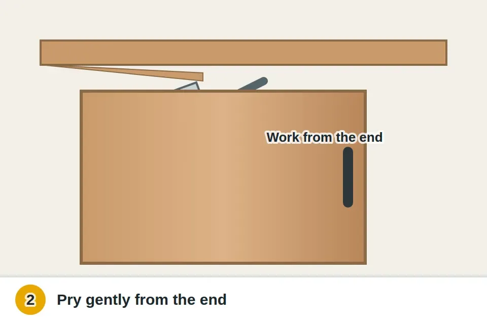 Putty knife and small pry bar easing the split jamb strip off the head of the opening from its end, so the top of the door and its hangers are exposed