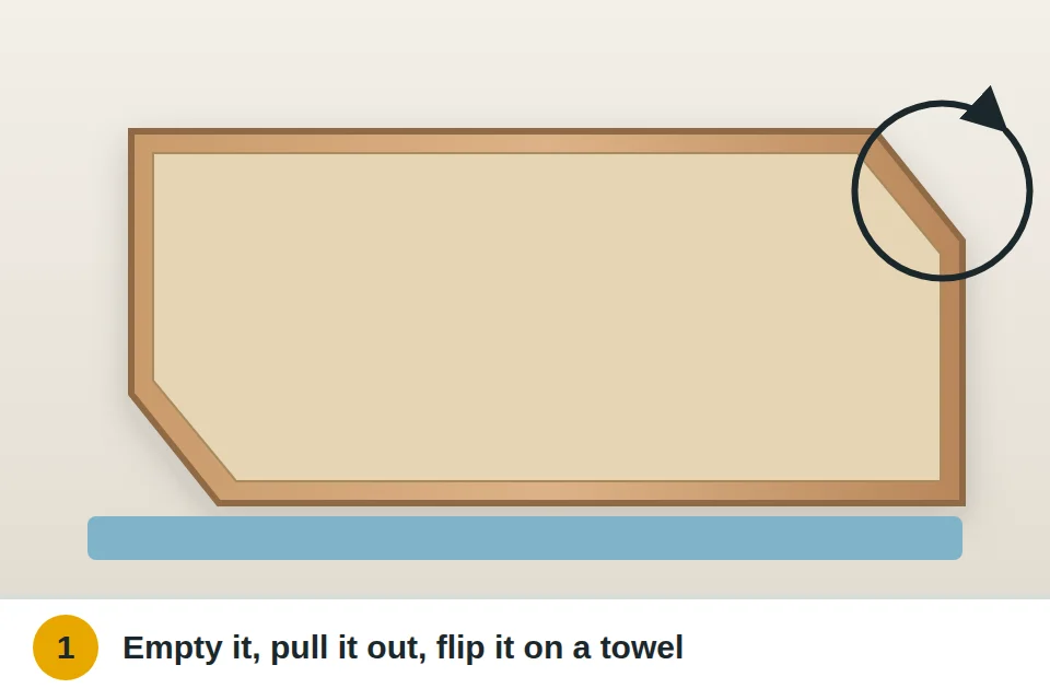 Drawer emptied, removed and set upside down on a towel