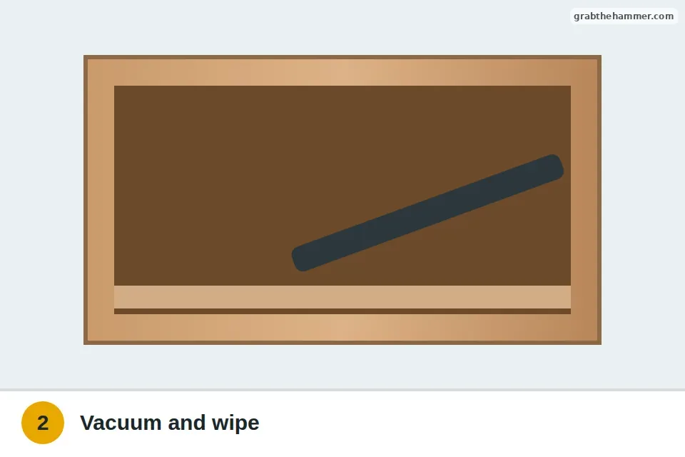 Vacuum hose cleaning dust out of the drawer opening and off the runners