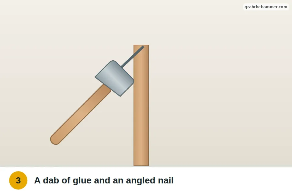 Small angled nail with glue driven through a baluster into the handrail