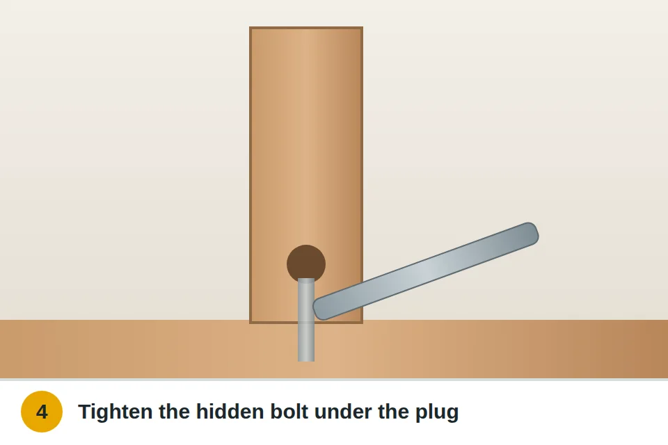Wrench tightening the hidden bolt at the base of a newel post, reached by removing a plug