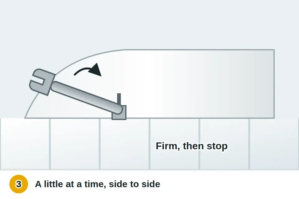 Wrench giving a floor bolt nut a small turn at the base of the toilet, alternating sides